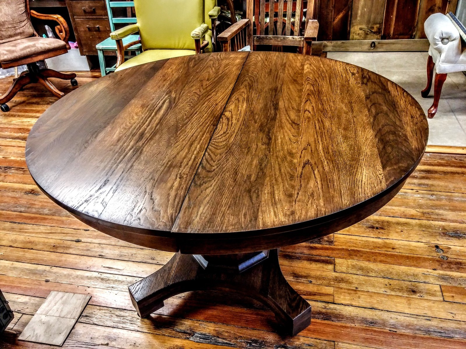 Round oak trestle dining table after refinishing