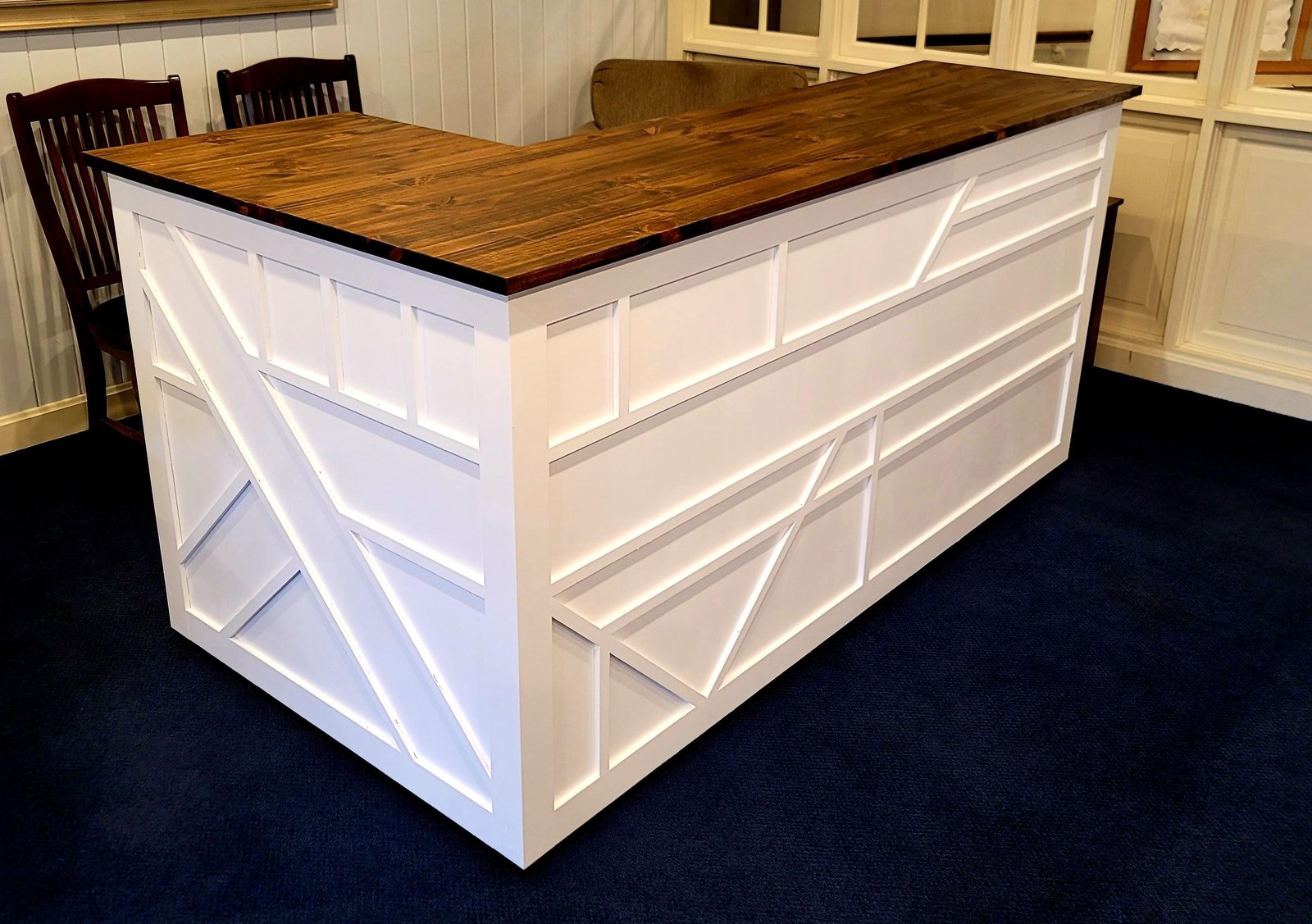 L-shaped white reception desk with wood top