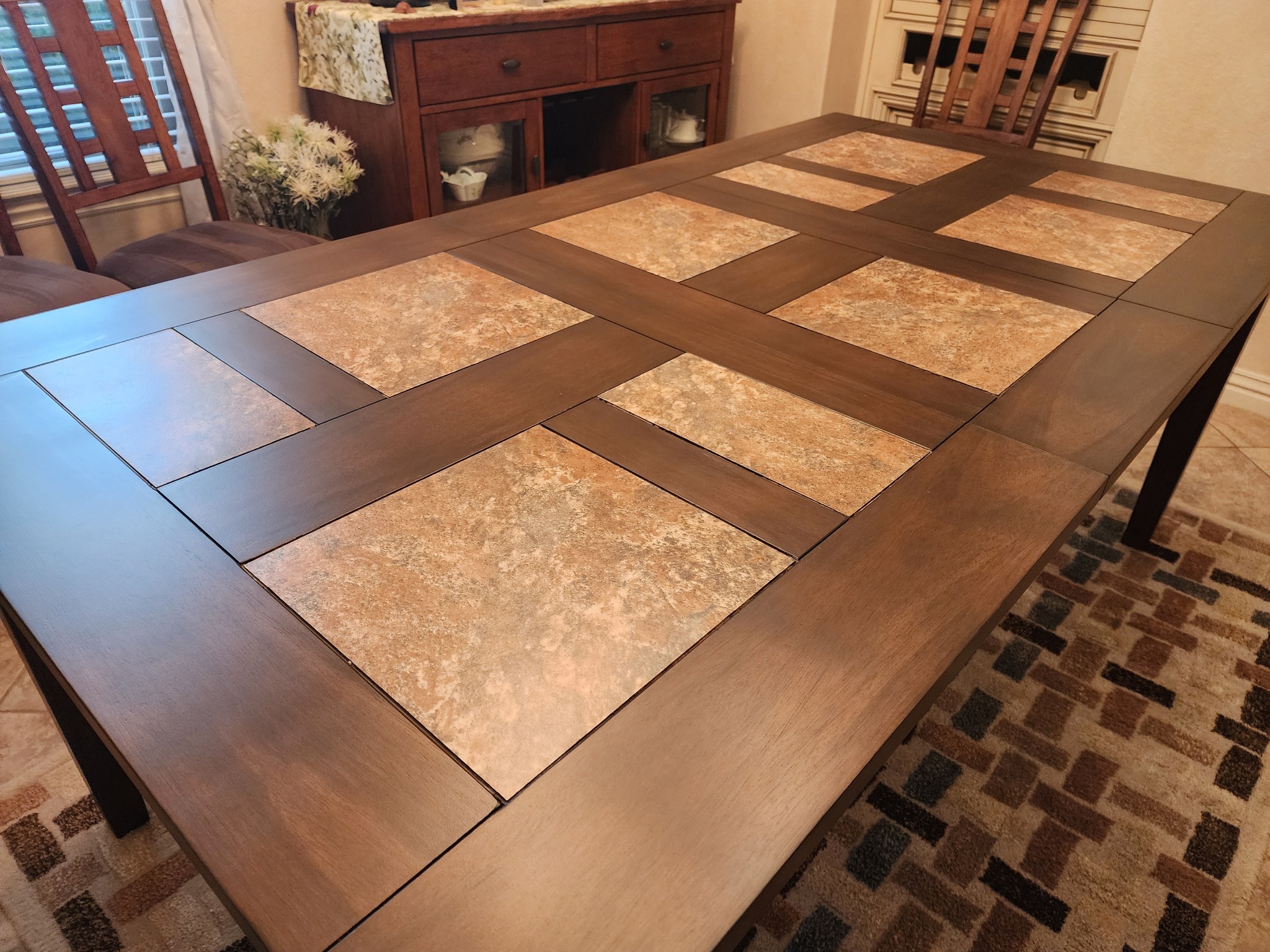 Wood dining table with decorative stone tile inlays restored.