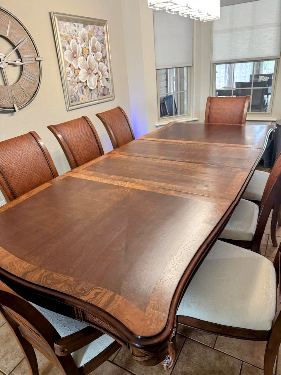 Large wooden dining table refinished with a rich warm tone.