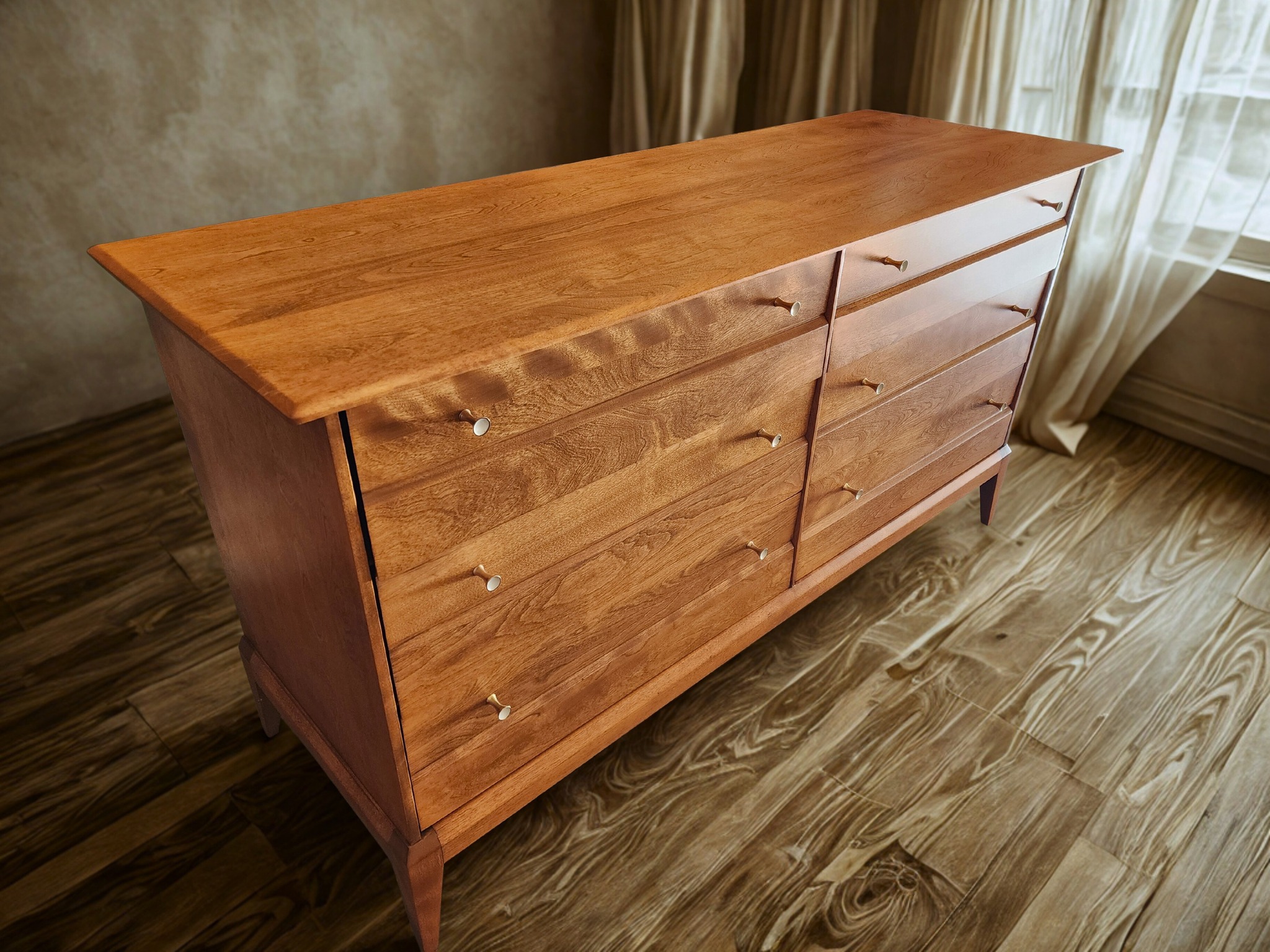 Mid-century wooden dresser refinished with a warm natural wood finish.